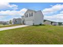 Two-story home with a large garage, light gray siding and black shutters at 600 Tudor St, Kingston, GA 30145