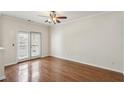 Bright bedroom features hardwood floors, ceiling fan, and balcony access, creating a cozy retreat at 1536 Liberty Nw Pkwy, Atlanta, GA 30318