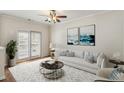 Bright living room with neutral tones, a ceiling fan, and a private balcony at 1536 Liberty Nw Pkwy, Atlanta, GA 30318