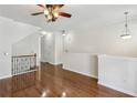Hardwood floors throughout living room with decorative railing and ceiling fan add a classic, bright aesthetic at 1536 Liberty Nw Pkwy, Atlanta, GA 30318