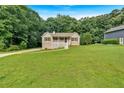 Charming home featuring a covered porch, white railings, a well-maintained lawn and driveway at 225 Hitchcock Dr, Villa Rica, GA 30180