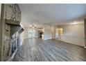 Spacious living room featuring an stone fireplace, new floors, and sliding doors to the backyard at 2478 Wood Meadows Sw Dr, Marietta, GA 30064