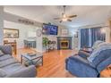 Inviting living room with fireplace, wood floors, and cozy seating area adjacent to a dining area at 252 Parkway Ct, Dallas, GA 30157