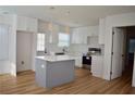 Bright kitchen featuring white cabinets, quartz counters, stainless appliances, and an island at 2502 Tupelo Se St, Atlanta, GA 30317