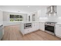 Bright kitchen featuring stainless steel appliances, quartz countertops, and ample storage at 425 Greenmont Walk Ct, Alpharetta, GA 30009