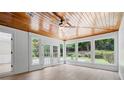 Light-filled sunroom with wood ceiling, views of backyard, and access to the outdoor patio at 425 Greenmont Walk Ct, Alpharetta, GA 30009