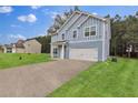Stylish two-story blue home featuring a two-car garage and well-maintained lawn at 4401 Belcamp Rd, Union City, GA 30213