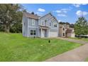 Inviting blue two-story home with a driveway and a lush green lawn at 4401 Belcamp Rd, Union City, GA 30213