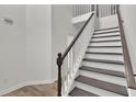 Elegant staircase with dark wood treads, white risers, and a classic banister at 4401 Belcamp Rd, Union City, GA 30213