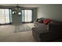 Inviting living area with cozy gray sectional and natural light at 6231 Redan Overlook, Lithonia, GA 30058