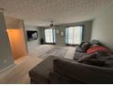 Comfortable living room with a large sectional sofa and plush carpeting at 6231 Redan Overlook, Lithonia, GA 30058
