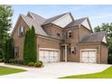 Spacious home with three-car garage and extra wide drive for additional parking at 5830 Caveat Ct, Suwanee, GA 30024