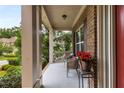 Inviting front porch with charming chairs and view of a beautifully landscaped lawn at 5830 Caveat Ct, Suwanee, GA 30024