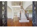 Elegant foyer with hardwood floors, a staircase, and arched doorways that exude modern appeal at 5615 Toccoa Dr, Douglasville, GA 30135