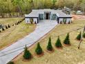 Aerial view of modern home with manicured landscaping and long driveway, showcasing its curb appeal at 0 Highway 279, Fayetteville, GA 30214