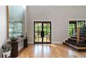 Bright foyer with hardwood floors, grand entryway, and staircase with black accents at 1380 Wayne Ne Ave, Atlanta, GA 30306