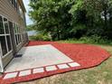 Backyard with a patio and fresh red mulch at 5669 Avonley Creek Dr, Sugar Hill, GA 30518
