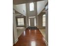 Bright foyer featuring hardwood flooring, transom window above the door, and lots of natural light at 5669 Avonley Creek Dr, Sugar Hill, GA 30518