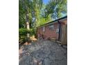 A stone patio area extends to the rear of the red brick home at 2875 Monterey Dr, Decatur, GA 30032