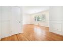 Bedroom featuring hardwood floors, trim, and a view of the outside at 2875 Monterey Dr, Decatur, GA 30032