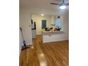 View of living room and kitchen with hardwood floors and white walls at 2875 Monterey Dr, Decatur, GA 30032