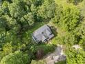 Aerial view of a home surrounded by mature trees, showcasing its privacy and wooded lot at 2958 Paul Harris Rd, Dallas, GA 30157