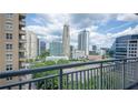 Excellent city view from a private balcony with trees in the foreground at 3338 Peachtree Ne Rd # 1506, Atlanta, GA 30326