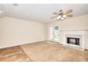 Welcoming living room with carpet, vinyl floors, fireplace, and French doors at 6344 Wellington Walk Way, Lithonia, GA 30058