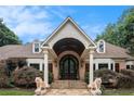 Grand brick home entrance with stone steps, stately columns, and decorative tiger statues at 7660 Treeridge Ct, Atlanta, GA 30350