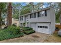 Charming home featuring a well-kept lawn, classic siding, and an attached garage, perfect for suburban living at 1377 Tucker Woods Dr, Norcross, GA 30093
