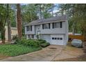 Charming home featuring a well-kept lawn, classic siding, and an attached garage, perfect for suburban living at 1377 Tucker Woods Dr, Norcross, GA 30093