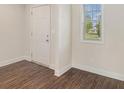 Bright entryway with hardwood floors, a window, and a white front door at 255 Orchard Dr, Covington, GA 30014