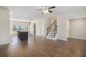 Open-concept living room featuring hardwood floors, recessed lighting, and staircase at 255 Orchard Dr, Covington, GA 30014