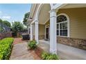 Inviting front porch with white pillars, arched window, and brick accents at 2721 Grapevine Cir # 1701, Cumming, GA 30041
