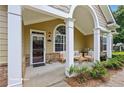 Inviting front porch with ample seating, elegant columns, and stylish decor at 2721 Grapevine Cir # 1701, Cumming, GA 30041