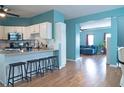 Open concept kitchen with breakfast bar seating, stainless appliances and view into the living room at 4336 Thorngate Ln, Acworth, GA 30101
