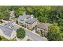 Aerial view of a brick home nestled among lush trees in a quiet residential neighborhood at 5971 Brundage Lane, Norcross, GA 30071