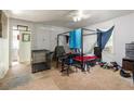 A bedroom with an open doorway, a bed with bedding, and disorganized personal items at 1151 Sheppard Pl, Stone Mountain, GA 30083