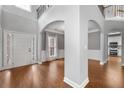 Open-concept living area features hardwood floors and natural light at 320 Roland Manor Dr, Dacula, GA 30019