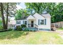 Cozy home with blue shutters and a small front porch framed by lush, green trees at 3261 N Fulton Ave, Atlanta, GA 30354