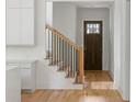 Bright entryway featuring hardwood floors, stairs with iron spindles, and a wood front door with glass panes at 370 Chicopee Dr, Marietta, GA 30064