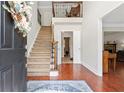 Inviting foyer with hardwood floors, staircase, and elegant entryway, and view to the formal living area at 3765 Peachbluff Ct, Duluth, GA 30097