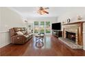 Comfortable living room boasting a cozy fireplace, hardwood floors, and abundant natural light at 3765 Peachbluff Ct, Duluth, GA 30097