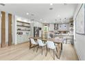 Open-concept dining area with modern table, wood columns, and an inviting kitchen view at 42 Riverdale St, Canton, GA 30114