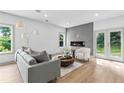 Cozy living room with a modern fireplace, sleek furniture, and a hardwood floor at 42 Riverdale St, Canton, GA 30114