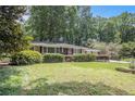 Charming brick home with manicured lawn and mature trees provides great curb appeal at 1747 Remington Rd, Atlanta, GA 30341