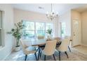 Bright dining room with a modern chandelier and a large window view of the outdoors at 1001 Dancing Fox Rd, Decatur, GA 30032