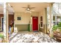 Inviting covered front porch featuring a ceiling fan and a bright red front door at 1001 Dancing Fox Rd, Decatur, GA 30032