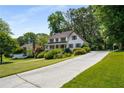 Spacious home with a long driveway and a well-maintained front lawn at 1974 Skyland Glen Dr, Snellville, GA 30078