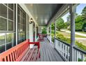 Cozy front porch with comfortable seating and classic architectural details at 1974 Skyland Glen Dr, Snellville, GA 30078